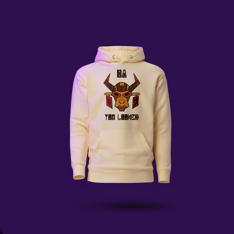 Cream hoodie with ceremonial tribal mask graphic and 'Ha! You Looked' text